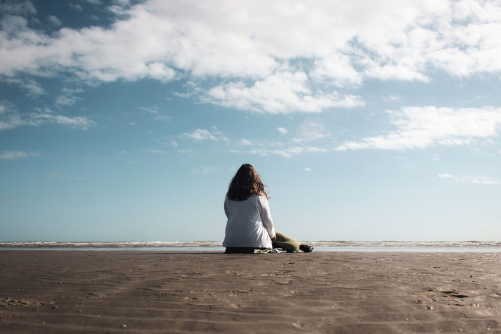 Alyx sitting on the beach