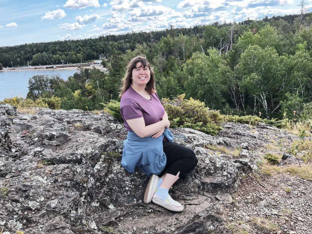 Alyx sitting on a rock.