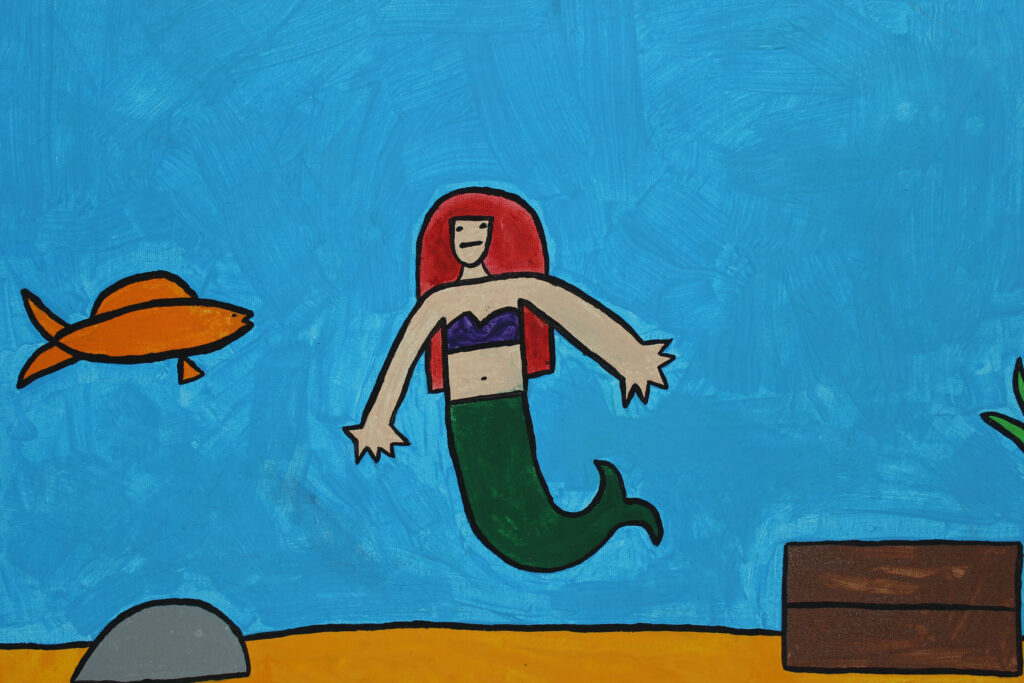 Mermaid with red hair with an orange fish.